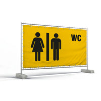 Bauzaunbanner – ein gelbes Banner, das an einem Bauzaun befestigt ist, mit schwarzen Piktogrammen für Damen- und Herrentoiletten sowie der Aufschrift WC.
