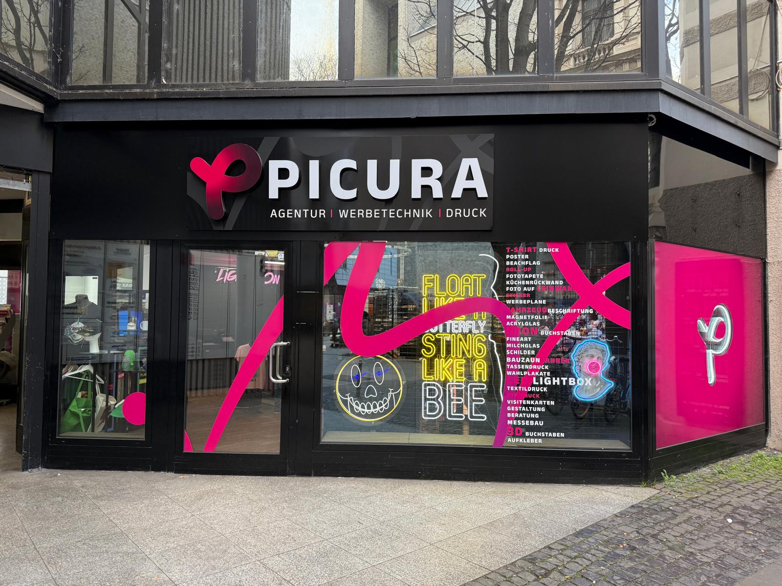 Copyshop Bonn Picura Ladenlokal mit Schaufensterbeschriftung, Neon-Schildern und Druckdienstleistungen