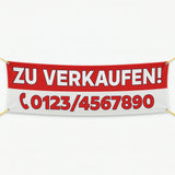 Rot-weißes Werbebanner mit "Zu Verkaufen" und Telefonnummer. Bei uns können Sie auch passende Roll-Up Banner drucken.